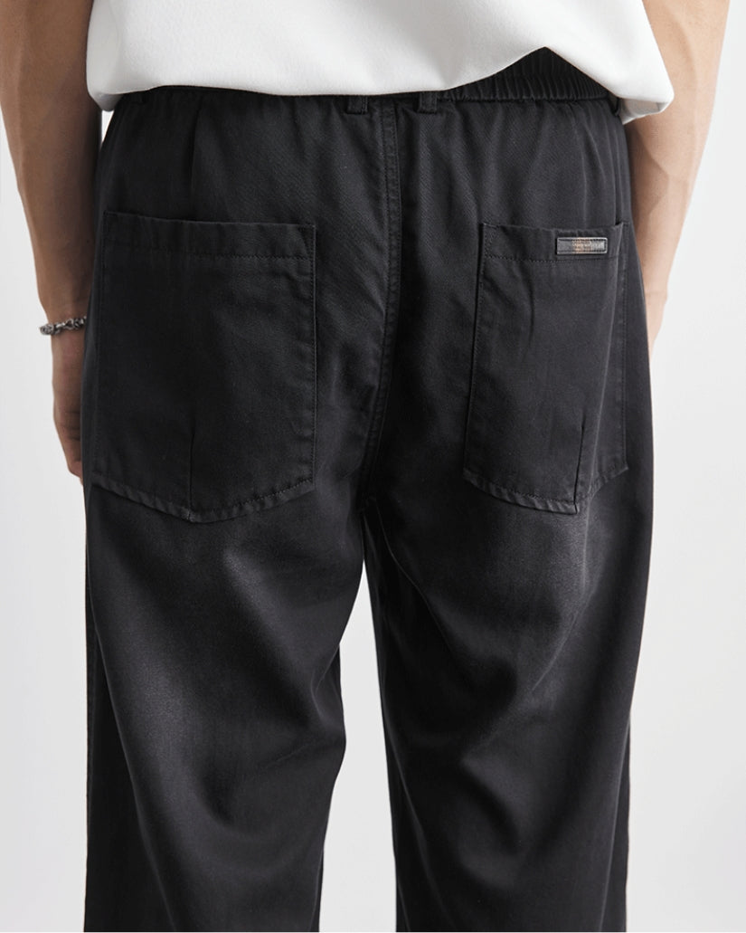 Baggy byxor med elastiskt midjeband och jeansliknande